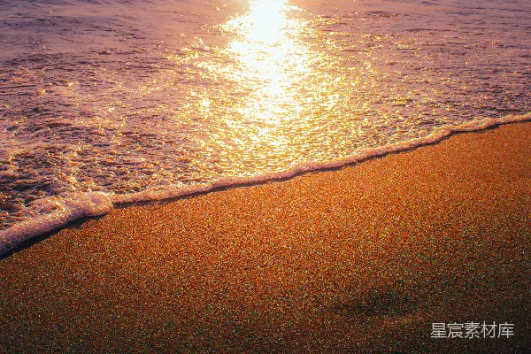 高清摄影 海浪在日落时拍打着沙滩。