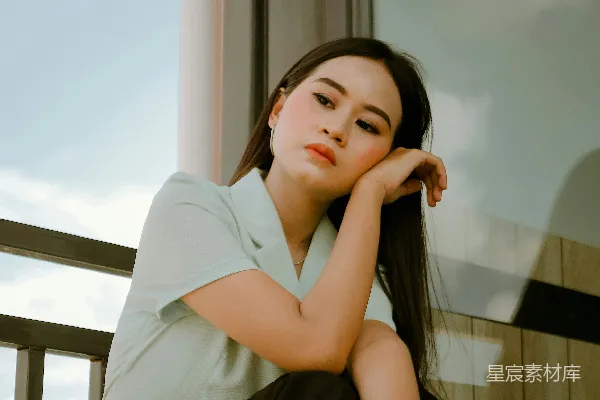 高清摄影 穿着白色衬衫的女人坐在棕色木制椅子上。