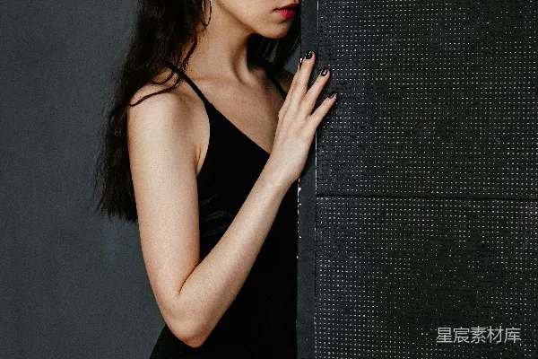 高清摄影 一个穿着鱼网袜的女人靠着墙。
