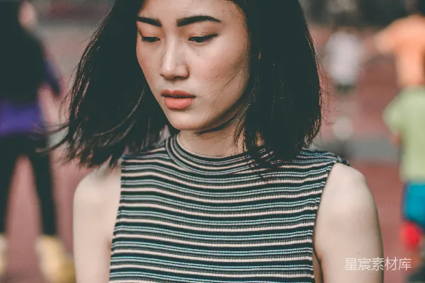 高清摄影 穿着棕色和蓝色无袖衬衫的女人站着。