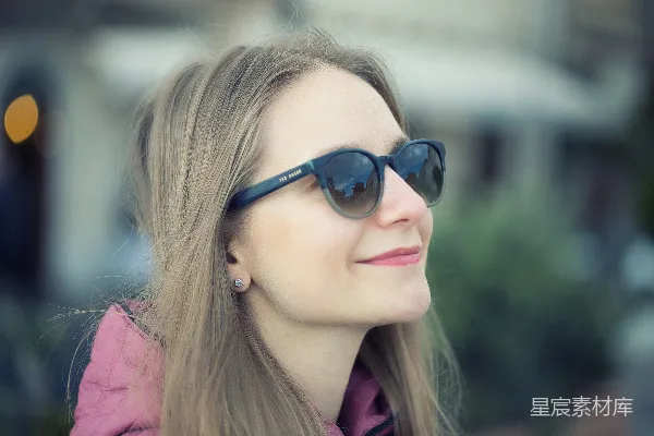高清摄影 一个戴着太阳镜的女人正望向远方。