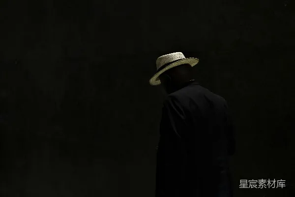 高清摄影 一个戴着帽子的男人站在黑暗中