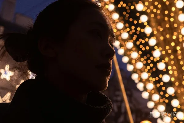 高清摄影 一位女士站在圣诞树前。