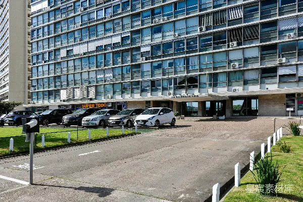 高清摄影 现代化的多层建筑前停着汽车。