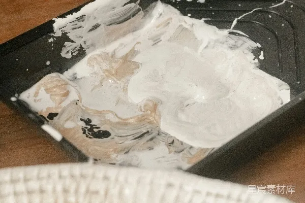 高清摄影 一张桌子，上面放着一个黑色托盘，托盘上有白色油漆。