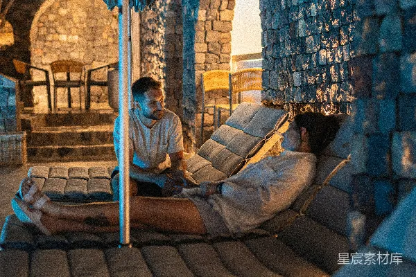 高清摄影 两个人在夜晚户外石拱门附近交谈。