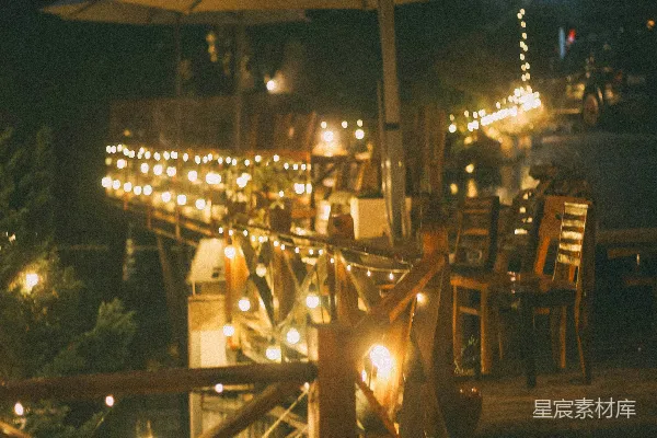 高清摄影 户外咖啡馆座椅在夜晚有串灯装饰。