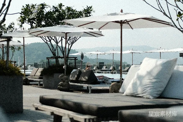 高清摄影 泳池边有带遮阳伞的躺椅。