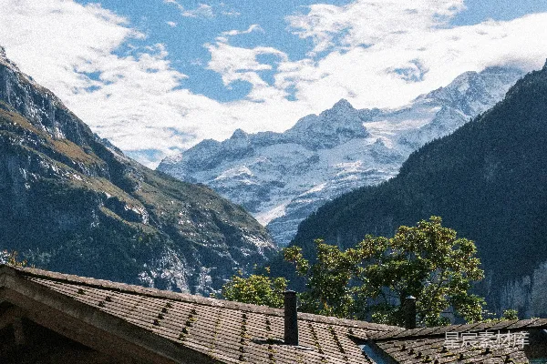 高清摄影 木屋屋顶，背景是积雪的山脉