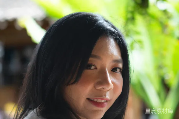 高清摄影 一个穿着白衬衫的女人拿着手机。