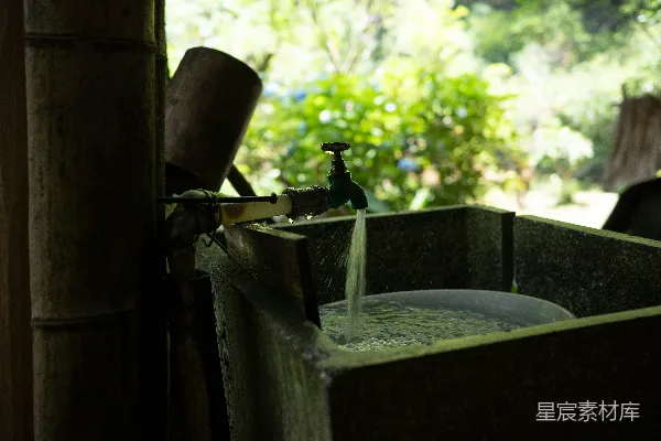 高清摄影 水从水龙头流进一个木制的盆里。
