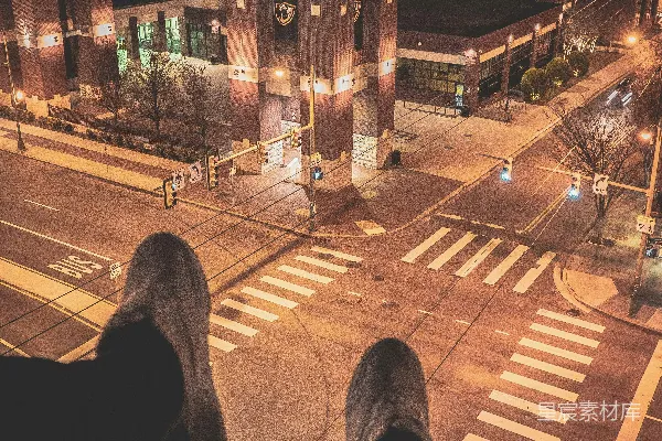 高清摄影 一个人坐在楼顶，俯瞰着灯火通明的街道。