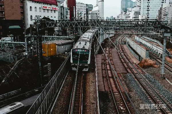 高清摄影 绿白相间的火车在轨道上行驶，白天时分。