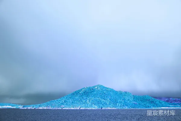 高清摄影 一块巨大的冰山漂浮在一片水域上