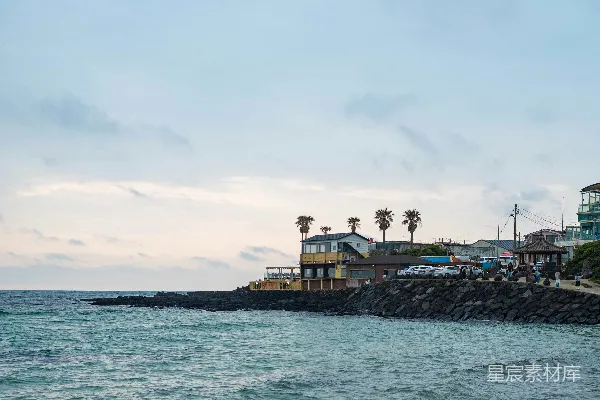 高清摄影 宁静的海滨景象，有建筑物和海浪。