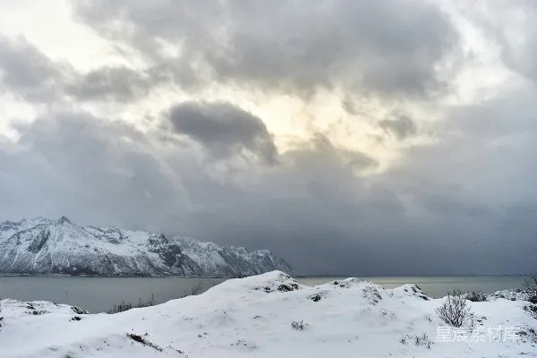 高清摄影 白雪覆盖的景观下，云层厚重、天空显得戏剧化。