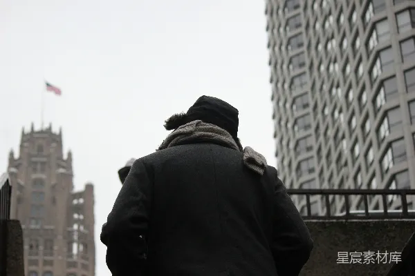 高清摄影 一个人在寒冷的城市里朝一座建筑物走去。
