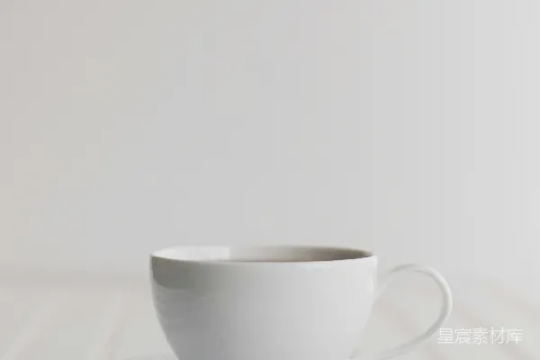 高清摄影 一个白色的杯子和碟子放在一张白色的桌子上。