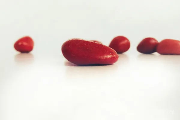 高清摄影 一盘红色的红豆放在白色桌子上。
