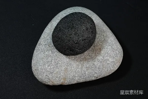 高清摄影 两块光滑的石头，一块深色，一块浅色。