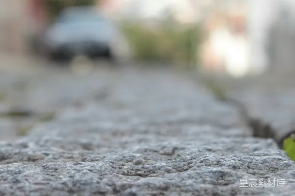 高清摄影 灰色纹理的石头表面通向模糊的街道。