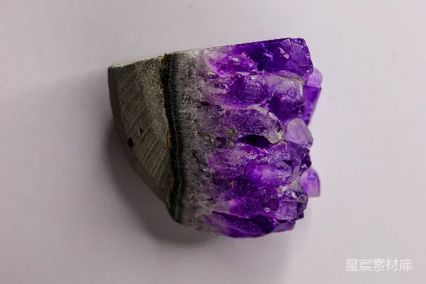 高清摄影 在白色背景上的一颗鲜艳的紫色紫水晶晶体。
