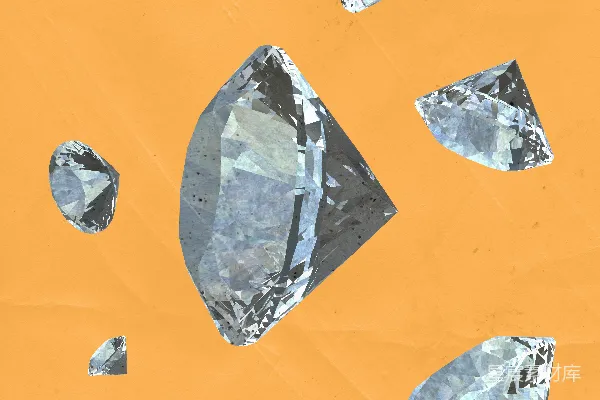 高清摄影 几颗钻石散落在橙色背景上。