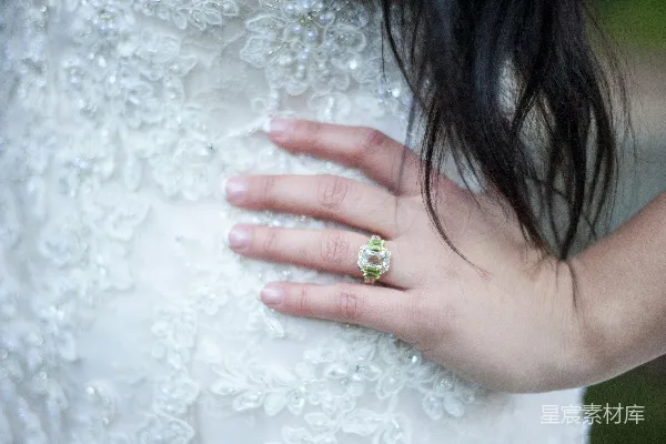 高清摄影 新娘的手在婚纱上戴着订婚戒指