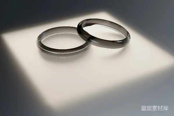 高清摄影 两枚结婚戒指放在一个白色表面上。