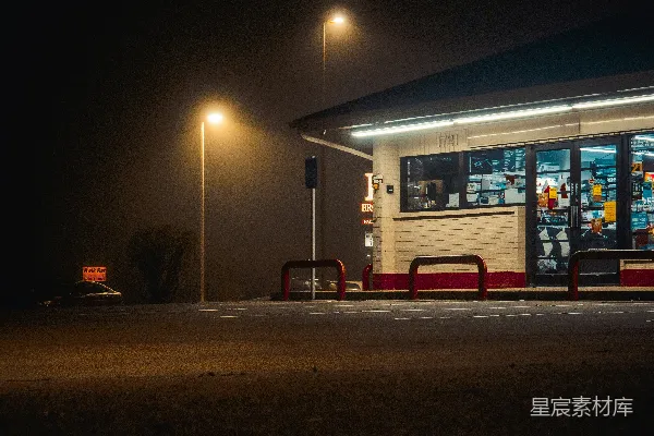 高清摄影 夜晚的加油站前有一张长凳。