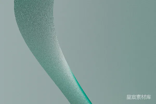 高清摄影 一个绿色的弯曲物体在灰色的背景上。