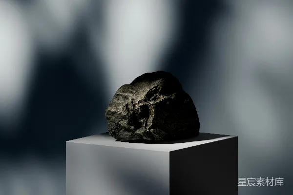 高清摄影 一块岩石坐落在一个白色的方块上