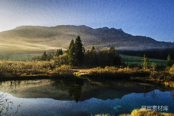 高清摄影 calm湖周边被树木环绕，靠近山峦范围