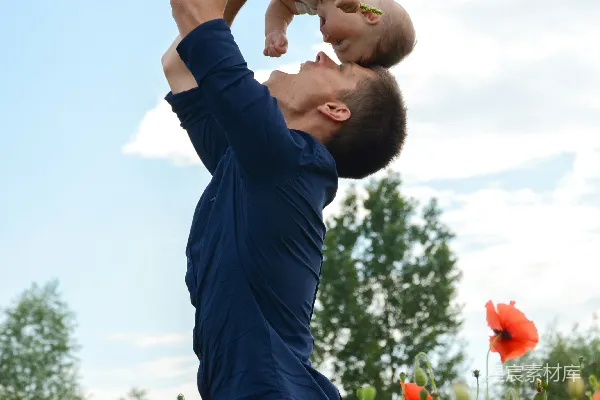 高清摄影 身穿蓝色长袖衬衫的男人抱着一件白色连体衣的婴儿
