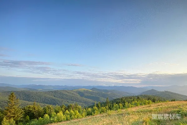 高清摄影 白天绿草遍野，山峦在蓝天映衬下